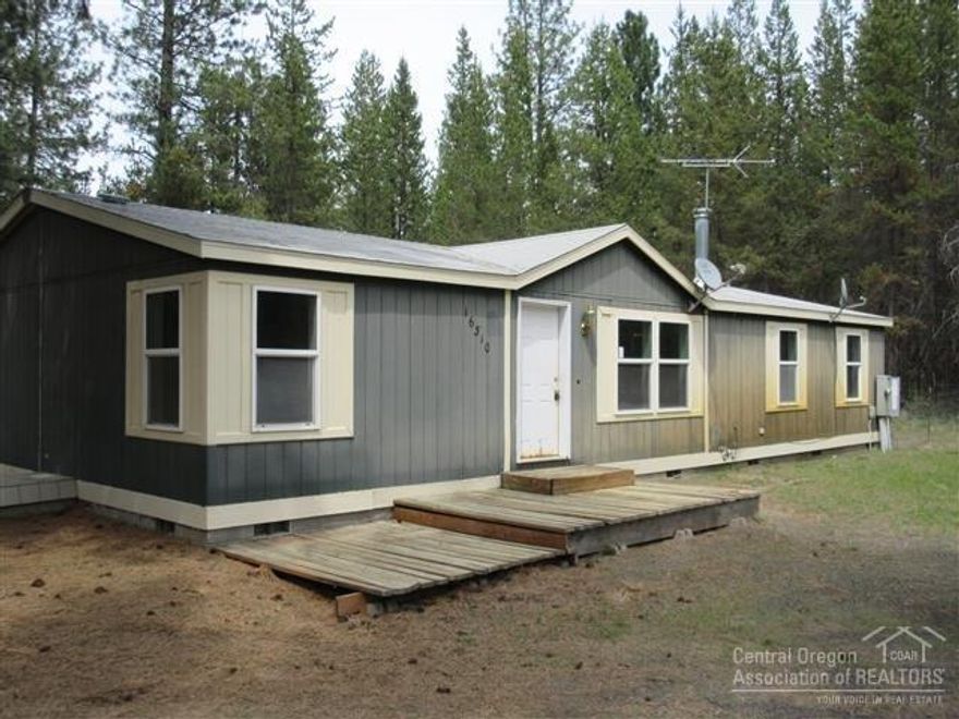 This HomePath property features new interior paint along with new kitchen appliances! Open Kitchen concept to the dining and living room. Sliding glass door leads out to the large out building with double French doors, light and bright and would be a great game room (former garage) Large ponderosa trees also grace this property giving it a lovely forest setting. Near the river.