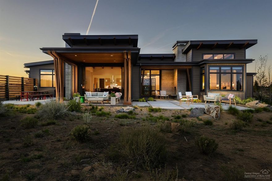 Breathtaking Bachelor and Tetherow views, birds chirping, high desert landscape, and the big Bend sky are just a few natural elements to be enjoyed from back of this unique property in Tartan Druim. Situated on close to an acre, this absolutely stunning custom contemporary single level home features exposed beams, structural board form concrete, metal shed roofing, two wood burning fireplaces, la cantina style doors, split oak cabinets, hand scraped white oak floors, Rejuvenation lighting, and so much more. With 3 bedrooms, 3.5 baths and office inside the main home & an additional casita w/full bath, the property offers function for many types of households. Plenty of storage with 3 car garage and a large mud/utility room, A/C and many windows to soak in natural light are of some of the additional interior amenities. Outside spaces include a crushed granite approach perfect for cornhole or bocce, picnic and bbq area in back, outdoor fireplace and multiple seating areas. One of a kind!