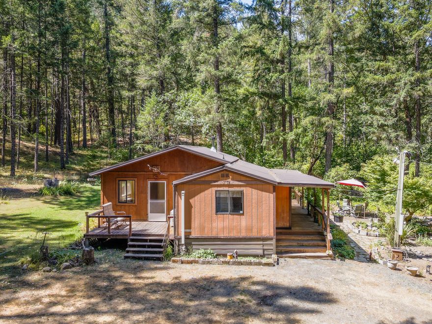 !!Owner Carry Financing, with a low down payment of $20K, interest rate between 6.5-7% depending on credit.  Private living with 6.5 off-road acres of beautifully wooded land that corners BLM. All the firewood you might need right in your back yard! The main home is a 2 bed 2 bath with a bonus room and has three types of heating. The kitchen features a breakfast bar and washer/dryer hook ups in the small pantry area.  Double paned windows, eight year old roof, PLUS Newer water heater and brand new pressure tank for well.  Several small outbuildings for tools/equipment, two car double carport, covered front porch area and outdoor sitting area shaded with trees.