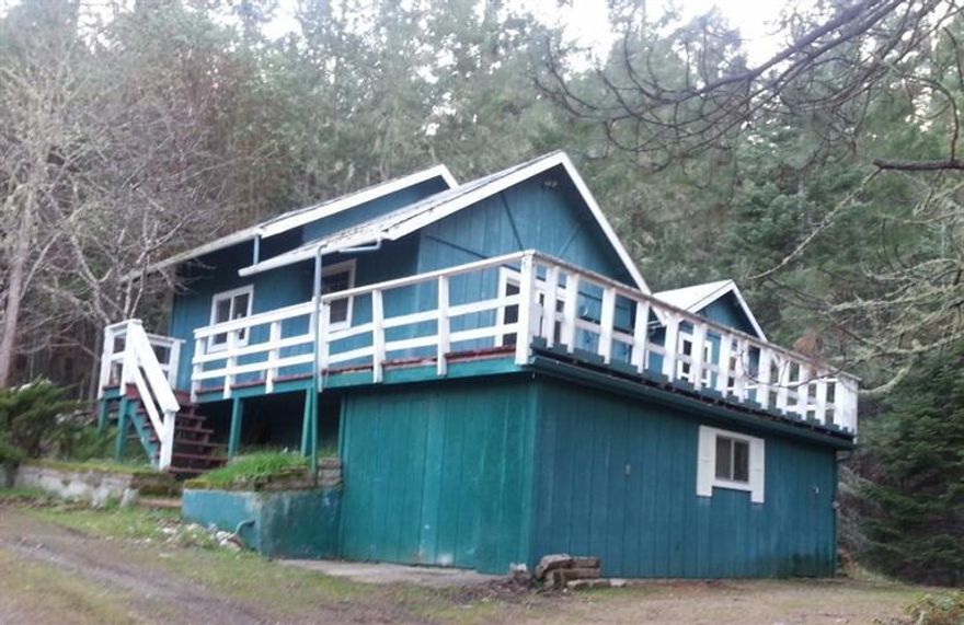 Situated in scenic Williams, OR. 10 forested acres surround this rural home.Multiple out buildings, detached garage, large deck, second story. With some TLC this could be an amazing property