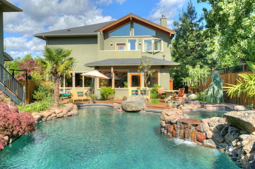 An entertainer's dream and a warm family home with nature throughout - a great stone fireplace, the sound of fountains, a sunroom atrium, and an all-seasons porch room with built-in barbecue grill. The huge cook's kitchen with granite counters and six-burner Wolf range opens to both the dining and living rooms. A romantic light-filled vaulted master suite is outfitted with a private terrace, double steam shower, oversized soaking tub, charming Italian tilework, and large walk-in closet. Outside, there's a gorgeous salt water pool and hot tub with waterfalls surrounded by a curving wooden deck, mature trees, and landscaping. All bedrooms - as well as the guest house - have wonderful expansive views of hills and trees. The residence is also equipped with a media room, home gym, and office. Don't miss this opportunity to own one of the most beautiful and welcoming homes in Ashland!