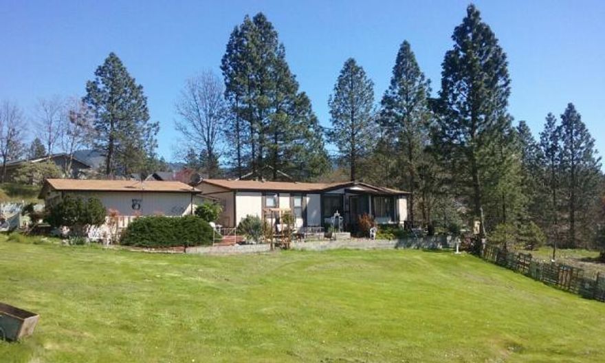 .83 of a useable acre, right in town yet privately tucked up on Hill Top Drive, this property has amazing views, superior convenience and a quiet setting with development potential. This is a beautiful house & shop, remodeled with artistic taste and great 'flow'; 1539 sq. ft., 3 bedrooms, 2 full baths and a fantastic open & vaulted living area, views from the kitchen with breakfast bar out to the large picture windows, great for entertaining as well as a true master suite double the pleasure, double closets in both the bedroom as well as master bath, double vanities with glass sinks, soaker tub and shower. ALMOST EVERYTHING IS NEW: roof, skylight, heat pump, hot water heater, plumbing, glass bath sinks, kohler kitchen sink, fancy pullout faucet, gas cook top, dishwasher, counter tops, showers, tub, beautiful wide plank laminate wood flooring, linoleum, new exterior skirting, new paint and a new deck off of the enclosed sun porch. Super cute (route 66) 2 car garage/shop has ample stora