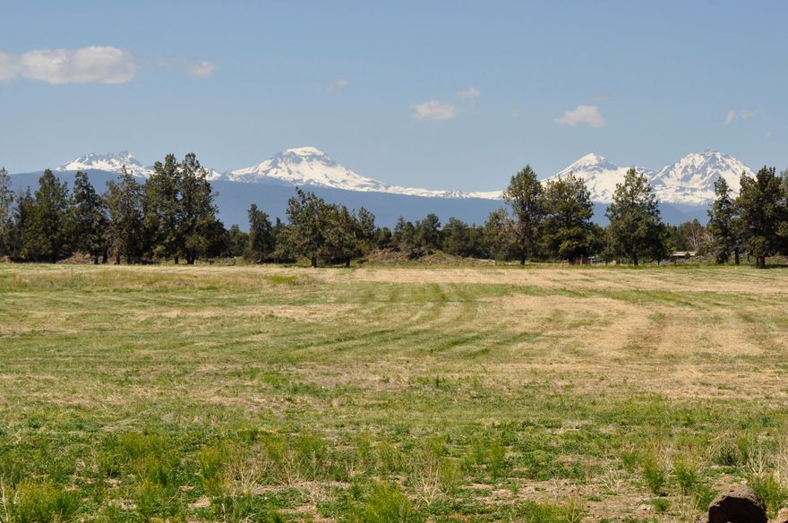 Rare large vacant acreage consisting of two legal lots of record in the desirable NE area of Bend, conveniently located within short driving distance of Bend, Tumalo and Redmond. +/- 68.24 ac and +/- 5.48 ac with COI water rights of 54.2 ac and 2.8 ac respectively. The east boundary of the parcel abuts a very large block of public land expanding your recreational activities right out the back door. These properties have been under the same ownership for over forty years and used as a cattle ranch. Big Cascade Mountain views from the elevated rock outcroppings on the east end of the property with several nice potential building sites. Buyer to do their due diligence regarding any/all land use like CUP's, land division, and water rights. Property has most of the perimeter fenced however the fence lines may not be on the property boundaries.  Newer 3000 sf steel beam hay/equipment barn.