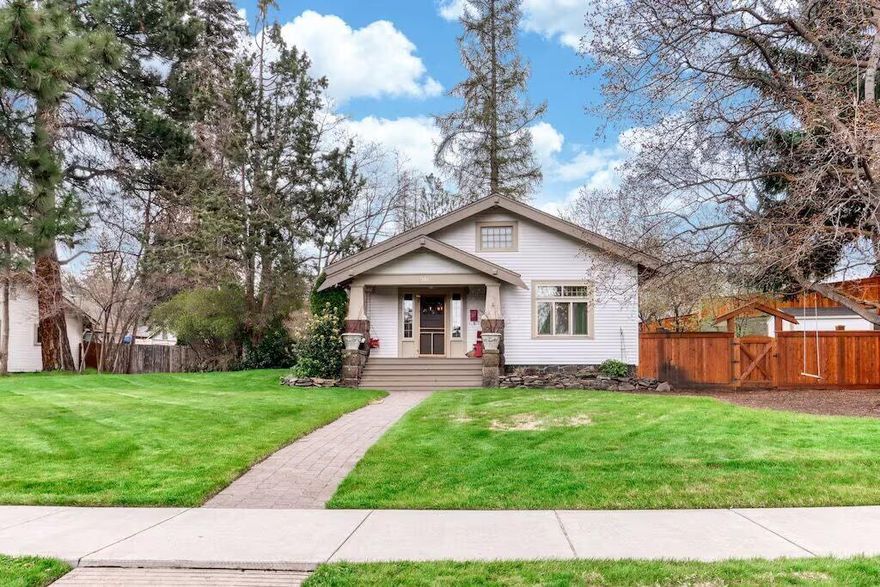 Well hello there, I'm a lovingly restored vintage Craftsman bungalow nestled right in the heart of Bend. I've seen a lot in my time, but lately? I've never looked better. From my charming front porch you'll catch mtn views perfect for morning coffee/evening wine. I sit proudly on a spacious lot w/ serious curb appeal & if you think I'm good looking from the outside, wait until you see my insides. Impeccable craftsmanship runs through every inch of me—from custom cabinetry & fine trim to restored hardware & gorgeous lighting. My gourmet kitchen? Marble counters & top-tier appliances, darling. Let's not forget my original wood floors & signature Bend blue pine ceilings; I'm all about timeless character. Wander just a few blocks & you'll find yourself downtown, at the river, or catching a summer concert. But don't rush my iconic stone patio & classic porch are made for lingering. Oh & I'm zoned CN. That's rare. So whether you're dreaming of business ideas or my STR permit, I've got you!