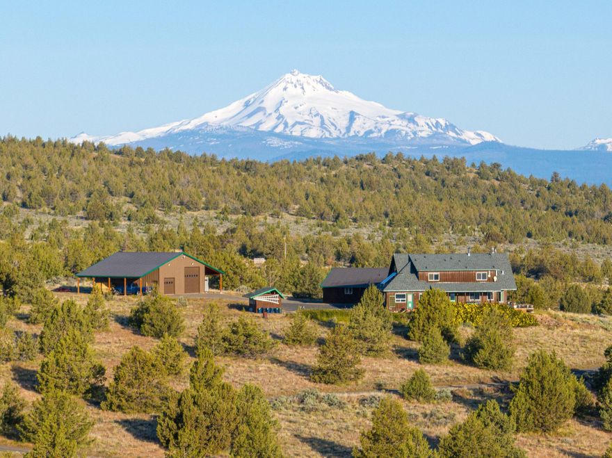 Looking for privacy without sacrificing convenience? This stunning 79-acre estate offers the best of both worlds—seclusion and sweeping views, just minutes from town. Surrounded by open grasslands and bordered by National Forest, this one-of-a-kind property features a beautifully crafted 2,900 sq ft home with 3 bedrooms, 2.5 bathrooms, an office, and a versatile bonus room that can serve as a 4th bedroom. Enjoy panoramic 360-degree views from every window.

A detached two-car garage includes a charming guest house—perfect for visitors or multi-generational living. The property also boasts a large RV garage/shop, fully insulated with a 50-amp hookup, concrete floors, and a durable metal roof—ideal for storing all your Central Oregon adventure gear.

Lovingly built and meticulously maintained, this home offers the peace and space you've been dreaming of, all within easy reach of town amenities. Don't miss this unique opportunity to live your Central Oregon dream!