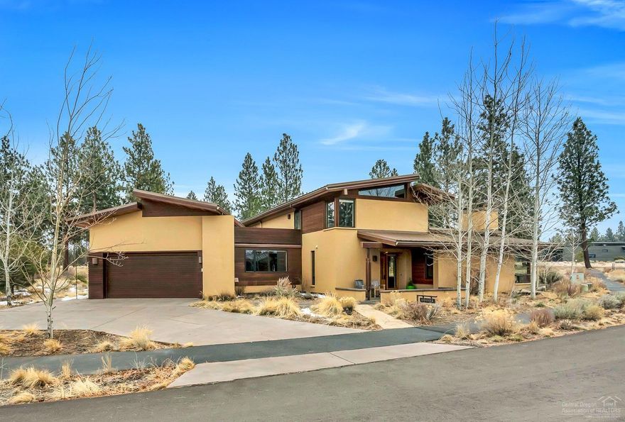 Beautiful northwest contemporary custom home built with sustainable resources in desirable Shevlin Commons. Ride and hike right from the house with access to miles and miles of trails. Modern styling yet warm and inviting throughout with custom woodwork, decked ceilings, exposed wood and steel beams, a catwalk over the great room and a wood burning fireplace in the living room. Energy efficient radiant heated concrete and fir flooring keeps the home cozy in the winter and cool in the summer. Large downstairs bonus room and additional flex space with full bath that is currently set up for guests. Gourmet kitchen with concrete counters, Cascade mountain views from various rooms, a dedicated office, 3 outdoor living areas including a roof top deck as well as a flag stone patio with hot tub complete this remarkable property. Be sure to view the virtual tour and full amenities list that includes recent improvements since 2016 as well. Truly a must see!