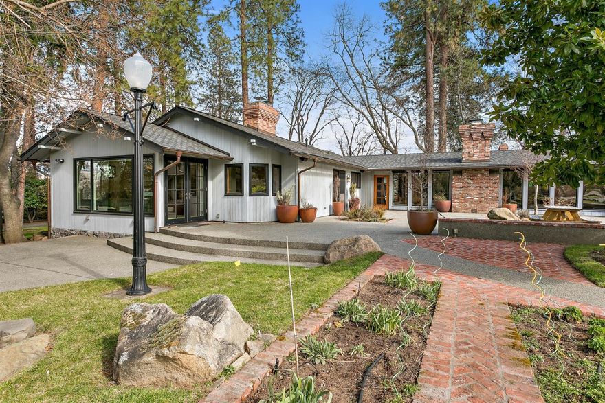 Magical setting just outside the city limits. Lovely 3 bedroom, 3.5 bath ranch style home nestled among mature trees and surrounded by manicured lawns,beautiful flower gardens, large vegetable garden, pool, fruit orchard and TID irrigated pasture. Tile and hardwood, light and bright kitchen and gorgeous master suite with walk-in. 2000+ SF insulated shop/studio/additional garage w/ HVAC and bathroom. The main house and large studio/shop have city water and are situated on one of the 3 contiguous irrigated and East facing parcels. Charming pool house with bath. Large pond. Incredible, fully fenced garden. Gated driveway, fenced and crossed fenced. Stunning as it is but also provides an opportunity for compound living at its finest. This sale includes two additional, buildable tax lots consisting of 4.7 acres and 4.20 acres.