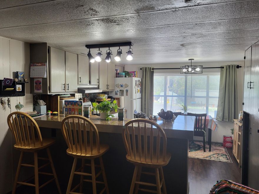 All-age park.  7001 Rogue River Hwy, #23.  Super clean sgl-wd, 2bd, 1 full bath, new carpet, new laminate, recently serviced plumbing and recently  rolled roof coat.  Included is washer, dryer, range, fridge, 3 bar stools at the breakfast bar, patio furniture and shed.  No mobiles in back of this unit and conveniently located between Grants Pass and Rogue River.  This mobile is MOVE-IN-READY !!!!