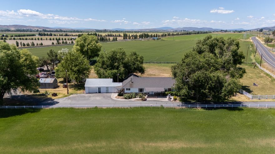 MOTIVATED SELLERS! Bring your hobbies and dreams to this rare 24.79-acre property. Space for your horses, livestock, equipment, and so much more! Established rental income included. This ranch has 23.7 acres of Class A KID irrigation rights. Zoned FR and  located just 5 mi from Merrill. The original ranch-style brick 2,850 SF 4BD/2BA home includes an expansive master suite, wood fireplace, natural oak and marble features. The detached one-car garage offers ample storage space and bonus room. The 1,680 SF ADU manufactured home offers 3BD/2BA with an oversized two-car detached workshop garage and many custom updates. Custom hay barn, with 500-ton capacity with finished railing for options of equestrian use. Large hand-hewn timber barn, corrals, and many other outbuildings. Fully fenced and cross-fenced with a new domestic well, agricultural well, mainline, and wheel lines. Outstanding opportunity with reliable water and fertile soil that once was a lakebed, offering excellent yields.