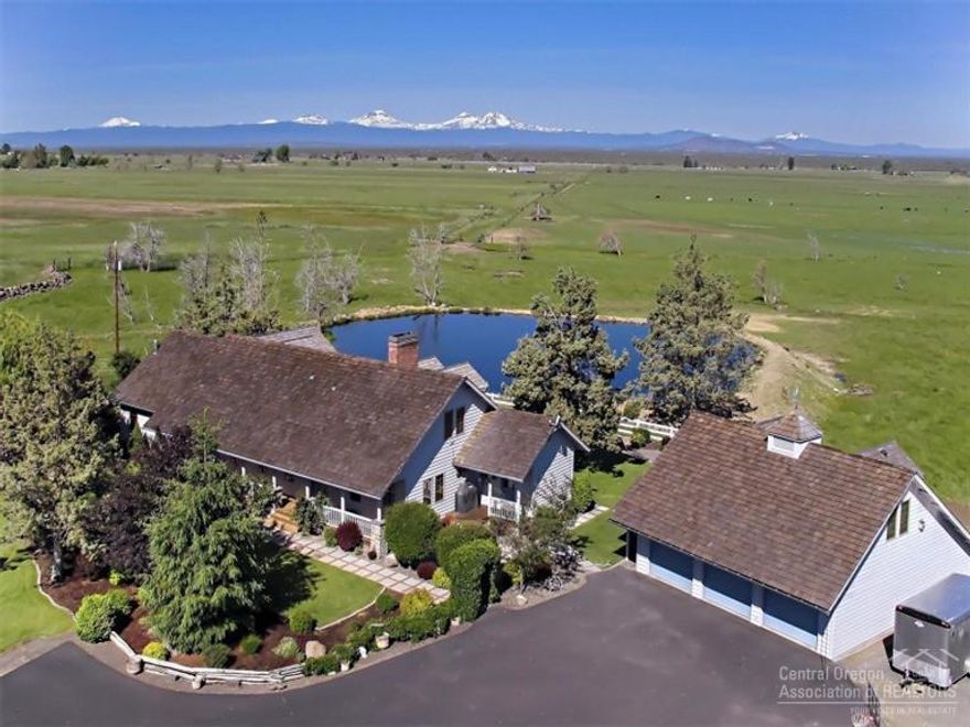 Riggs Road Ranch with Cascade Mountain & Smith Rock Views- 102.9 acres with 100 acres of COI water rights currently used for pasture and hay. Private custom home features: 3611 sq 3 bed/3.5 bath with spacious master suite w/garden tub, office, gourmet kitchen, decks landscaped. Detached 6 car garages (one has finished upstairs for office/game room) Shop with RV storage, Barns, Outdoor Arena, Hay Barn, Corrals & Property is Fenced. Additional 1156 sq ft home-3 bed 2 bath with outbuildings.