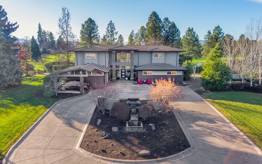 A beautiful blend of modern updates & classic Old East Medford charm on 14th fairway of RVCC on manicured 1.07 acre!  Circular drive & tranquil water feature!  2 master suites – 1 on each level!  Kitchen offers porcelain tile flooring, leathered granite counters, built-in fridge, gas range/oven, wine cabinet & fridge, pantry storage & eating bar.  Wet bar w/ice maker.  Gas fireplace & built-ins in living room. Large picture windows throughout.  Brazilian cherry hardwood floors upstairs. Office space w/built-ins + bonus room for 2nd office or hobby room w/tile viewing deck.  Large rec room w/French doors, walk-in closet & bathroom. Dble-door entry to main master suite w/2 walk-in closets w/built-ins, dble sink vanity, soaking tub & steam shower.  Covered patio & 2nd patio w/retractable sunshades.  In-ground pool.  Putting green & basketball court.  Outdoor eating bar w/gas barbecue & mini fridge.  Glass rock fire feature.  Attached garage w/half-bath, carport & detached golf cart shed.
