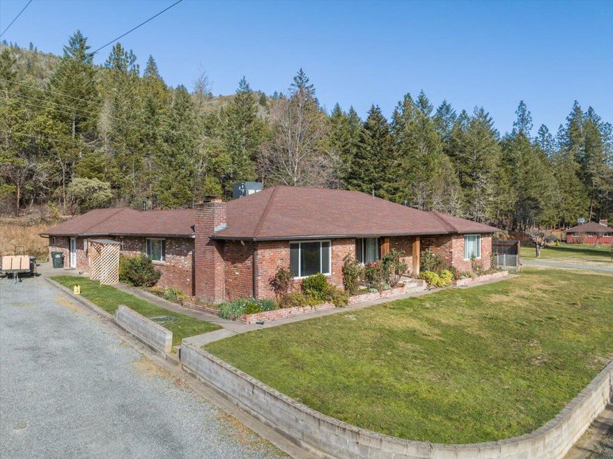 3 Potential rentals. Prime investment opportunity! This well-maintained property sits on 3.24 acres with mountain and river views, just minutes from the Applegate Valley
Wine Trail and Grants Pass. Spacious 5-bedroom main home, an updated 2nd home, and a beautiful cabin-style home in the middle.
Newer roofs, separate newer septics, and a half-basement wine/canning cellar. Multiple possibilities for long-term rental, multigenerational living, or portfolio expansion.
Outside you'll find peach, apple, and nectarine trees along with water rights for up to 2 acres. A rare asset for investors looking for agricultural or homestead potential.
Shop is 36x40, insulated and drywalled offering many uses: equipment storage, RV/boat parking, hobby space, or additional income potential. The playground adds even
more value for tenant appeal or family use. Lots of flexibility and earning potential don't come often. So much to offer and truly a must-see. Tour it today!