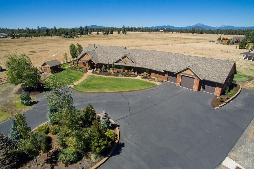 Beautifully appointed custom built home with spectacular Cascade and Mount Bachelor views. All of this in a single story home finished with soap stone counter tops, rustic cherry cabinets, gourmet kitchen, birch hardwood floors, open great room with timber framed and vaulted grand ceilings. Tulikivi soap stone wood fired stove with pizza oven. Pella windows, beautiful outdoor covered living areas with water feature and manicured grounds, circular drive. Over sized 3 car garage with large work spaces.