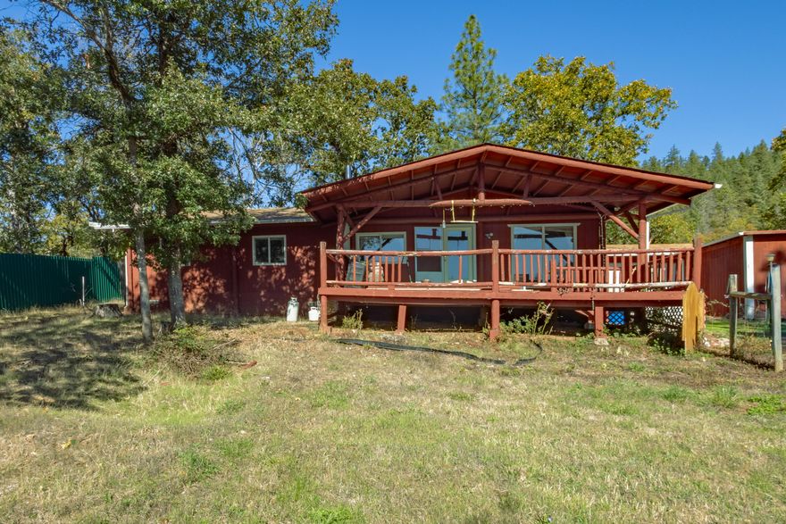 Step into this beautiful 1,200 sq. ft., two-bedroom, two-bath home with stunning mountain views! Enjoy modern living with vinyl flooring and carpet throughout. The detached two-car garage, equipped with workbenches, shelves, water, and power, is perfect for projects. A spacious metal barn and two additional metal buildings provide ample storage or workspace, complemented by a shop with a breezeway. The partially fenced property features a solar-powered gate and backs up to BLM land for privacy and outdoor exploration. A great producing well ensures self-sufficiency. This is your opportunity to own a versatile mountain-view retreat!