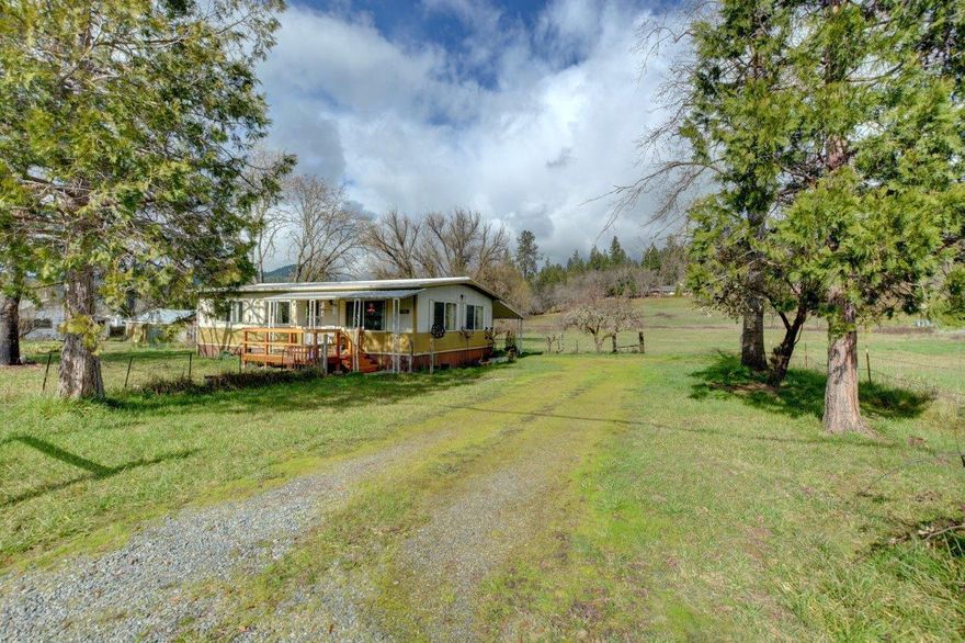 Beautiful Demaray rural neighborhood between the Applegate River and Rogue Community College.  Just outside of the fast developing Grants Pass southwest corridor.  Currently consisting of 2 homes - a Manufactured Home and a Stick Built Home which has been decommissioned into a storage building.  There's a garage, several outbuildings and two driveways.  New pump on the well.  The entire property of 4.85 acres is irrigated.  Buyer to do all due diligence regarding a second home - call for more details.