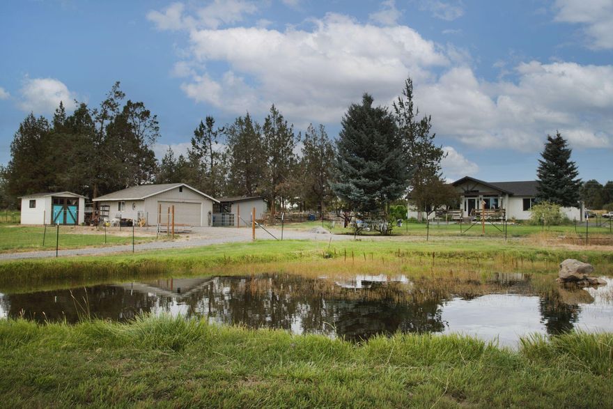 Newer 2020 single-level home on 2.5 irrigated acres with 2 acres of irrigation rights. Light and bright interior with vaulted ceilings, granite counters, great room layout, forced air, heat, and central A/C. Attached 2-car garage plus additional detached 2-car garage, storage shed with concrete floors, outbuildings, and a chicken pen. Horse setup with fenced pasture and two stalls. Centrally located turnkey hobby farm - a must see!