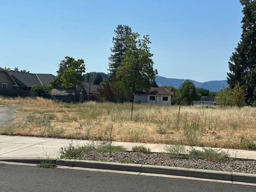 Fantastic opportunity to buy approximately 1.45 acres of flat buildable land in the Grants Pass city limits.  Water and sewer are in the street, power is on the property.  Located in an area of newer homes, this land could be potentially developed into one or more home sites (buyers to check with city planning for possibilities and restrictions. 
Currently there is a two bedroom, 1 bathroom cinderblock home which is connected to a well and septic.  The home is of no real value, the value is in the land.
Seller says they will consider all reasonable offers.