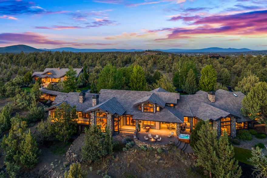 Private, yet, minutes from Bend, this stunning NW Style Estate built by Norman Building & Design sits on an extraordinary setting of 9.77 acres w' panoramic Cascade Mtn Views. Through custom gates, the old growth Juniper trees frame the entrance, welcoming you into an architectural masterpiece designed for indoor/outdoor living spaces, HW finishes & exquisite details. GR features custom rock wood burning FP, Views & massive beams w' iron details. Main home is 8676 sq ft w' 6 BR suites, + 2 baths, 6 car garage or 4 + RV. Chef's kitchen w' top of the line SS appliances & Slab granite island w'custom hood artistry & raised bar for informal seating, Copper counter wine bar wi' Jotoba bar cabinets, DW & sink. Wine Cellar & 3 wine refrigerators. Main level MBR suite w' Mtn Views, Gas FP, HW floors. Also on main level are 2 offices, + BR ste & bonus room w' custom billiard table & gas FP. Detached GH is 2095 sq ft & holds 5 cars or 4 + RV. Total sq ft is 10771 = $367 per sq ft.