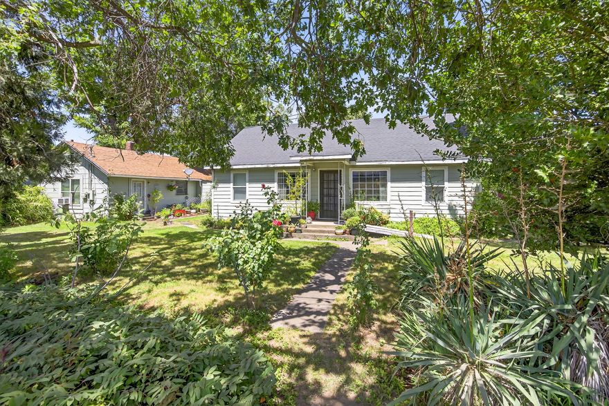 Great opportunity with this two family set-up situated on a 0.50-acre irrigated site with MID irrigation. The main home is a 1,530 sq.ft. single story 4 bedroom-2.0 bath home with lots of updates. The 2nd dwelling is a 2 bedroom-1.0 bath guest house with approx. 654 sq.ft. The main home has a newer composition shingle roof (2018), Hardy Plank siding, newer vinyl clad windows, covered front and rear porches. Interior updates include: newer kitchen cabinets and counter tops, carpet, vinyl and laminate flooring, newer plumbing and lighting fixtures. Primary bathroom has a combo shower & jetted tub. Both homes have new electric service panels. Large private yard with mature trees and  landscaping. Guest Multiple storage sheds and room for your toys. Call for appointments to show. Guest  is rented by a family relative.