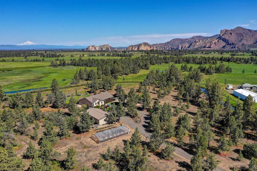 Gardener's dream in the Smith Rock valley! Enjoy unobstructed views of the Cascade Mtn range & Smith Rock State Park from this private oasis. 5+ acres just minutes from Redmond & Terrebonne. 2,154 sf single level home is immaculate. Spacious great room w/central kitchen, breakfast nook & 2 open living areas. Vaulted family room is lg enough for comfortable furnishings, a sun deck & pool table w/floor to ceiling gas fireplace. Sky lights & tons of windows fill this home w/natural light. Desirable floor plan w/Master Ste separation & tons of storage. Expansive Trex deck on west side of home is perfect for summer entertaining & a covered front porch for year round enjoyment. Water feature & magazine worthy landscaping w/plants chosen for the local micro climate provide an amazing backdrop. Micro vineyard & orchard have been started! Detached garage & shop is 1152sf w/office. Green house, raised garden beds, deer fencing & a gated entry. High producing well & RV parking - Don't Miss!