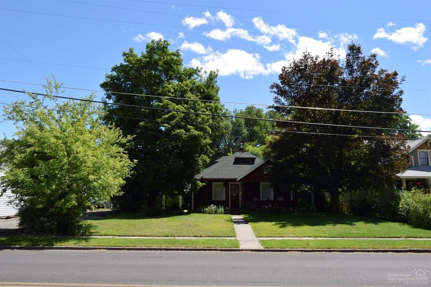 Gorgeous,Vintage,Craftsman cottage built in 1926 in Historical Neighborhood. Beautiful perennial landscaping welcomes you inside to enjoy the petrified wood stone fireplace, glass front built-ins, original oak floor, cozy light- filled sun room. Excellent location.The large fenced backyard is a secluded retreat with mature shade trees and includes a small studio, storage building, double carport/shop w/alley access. Come enjoy the world class out door activities, Central Oregon has to offer.