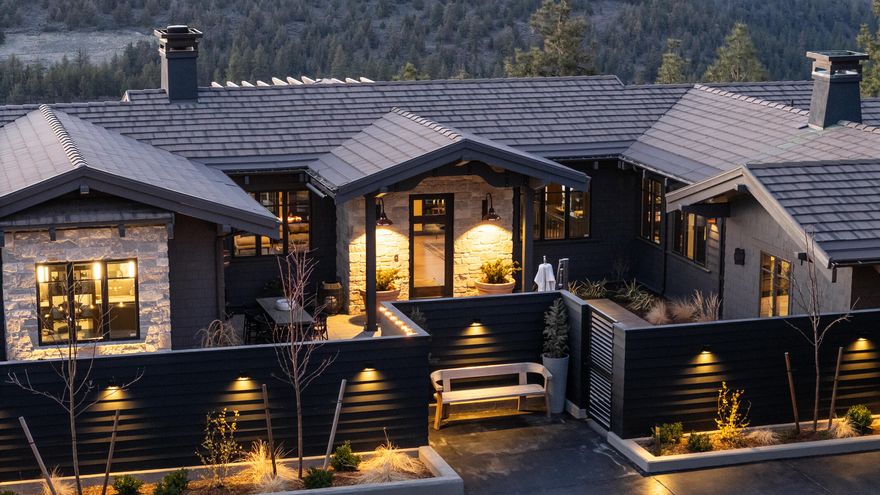 Exquisite North Rim residence showcasing panoramic Cascade Mountain views.  This incredible home has been extensively renovated and upgraded with a meticulous eye towards craftsmanship and quality of finishes and materials.  Experience comfort and relaxation in the primary bedroom wing boasting a cozy sitting area, stunning views, and a luxurious bathroom designed for both functionality and serenity.  An abundance of natural light in the great room with french door access to the expansive elevated deck.  The morning Alpenglow and evening sunsets will leave you breathless.  Incredible designer kitchen, butler pantry, den/office, and guest room with ensuite bath round out the main level.  Lower level includes 2 Beds/2 Baths, game/tv room, and bonus flex room, all with access to the beautiful & spacious halfmoon rear patio.  1,100 sqft private front courtyard with soothing fountain and welcoming hot tub/spa with a dedicated view of North Sister. 3-Car garage with heated driveway.