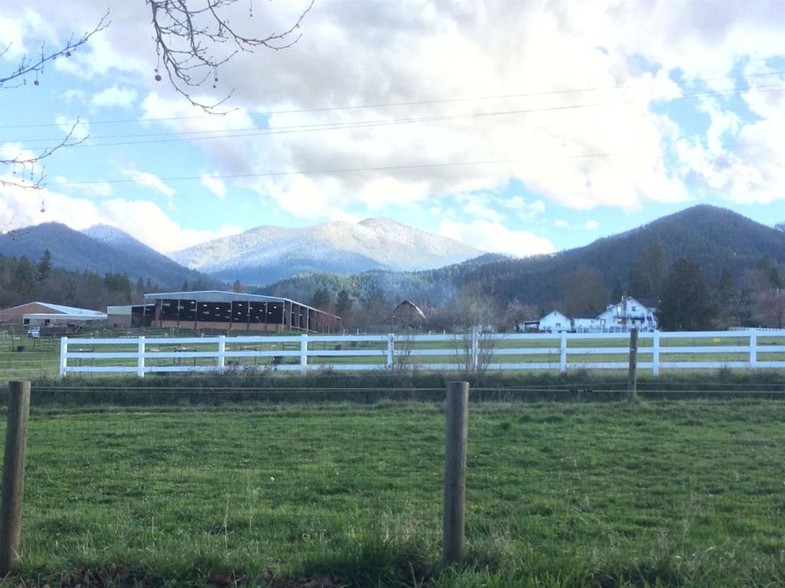 Beautiful views of Wagner Butte on Wagner Creek. 3 bedroom 2 bathroom main house, 1 bedroom 1 bathroom guest house. Huge hay barn, 4 horse houses with turnouts. wash stall/tack room/ chicken coop and a shop with 2-1000 gallon water tanks with pump for horses. 2.46 acres with irrigation from Beeson Robinson Ditch. On Talent city water. Back of property is Wagner Creek for cool summer days!
