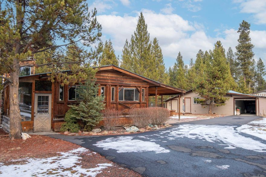 Your own private haven awaits in Central Oregon, where breathtaking adventure meets serene country living! This 2-bedroom (plus office), 2-bath log-style home sits on a fully fenced & gated 1-acre lot w/ mature Aspen trees, just minutes from Sunriver. Enjoy an open floor plan, a sunlit office, & an enclosed porch/sunroom/pantry for extra function. Updates include a remodeled primary suite with a walk in closet & deluxe bath featuring a fireplace, large tiled shower & second-story hot tub boasting treetop views. Additional highlights: 30 & 50 AMP RV hookups, a home generator system, & a large detached craft studio easily converted into an ADU.

With a paved driveway, RV cover, & garage, this property is perfect for primary, vacation, or investment use. An assumable 2.5% loan make it an exceptional opportunity. Located in Three Rivers South with easy access to Sunriver and Bend. Access via Pinewood.