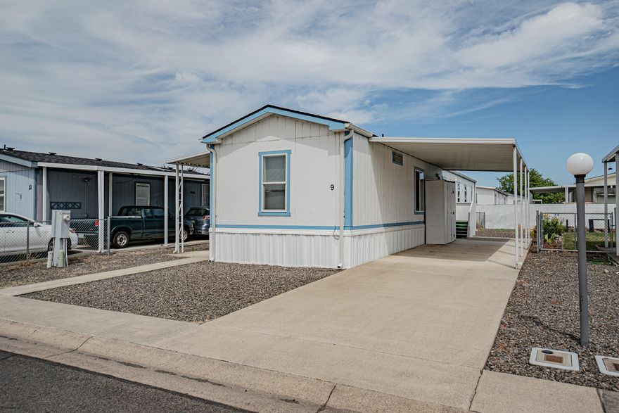 Check out this spacious open floor plan 2 bedroom, 2 bathroom, 924 sq ft single wide, 1991 built mobile home in a 55+ community. Recent updates include a new roof, new carpet, new double pane vinyl windows, newer water heater and about a 5 year old mini split HVAC system. Home features a split floor plan with a large primary suite, dual vanities, walk in shower, and a soaking tub. Kitchen includes plenty of cabinet space and an eating area. Hall bath includes a shower/tub combo and there is a separate laundry room. Property features an attached covered carport for parking, fenced backyard, low maintenance landscaping and a storage container. Monthly lease fee is $500 which includes sewer and garbage. Call for a tour today!