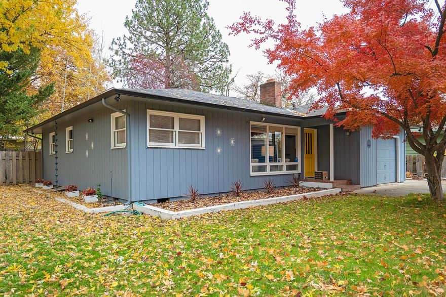 Enjoy this timeless, Mid-Century Modern home, in the heart of Old East Medford. With two inviting living spaces, this 3-bedroom, 2-bathroom home offers modern living while preserving its retro charm. The front living captures the stunning views of the fall leaves, enhanced by a cozy gas fireplace and the original oak hardwood floors that flow throughout most of the home. The retro-inspired spare bath adds to the authentic charm. The kitchen has a breakfast nook, abundant counter space and tiled backsplash that goes with the home's era along with a barn door slider leading to the back room. The back living room is perfect space for relaxation and has a dining room for gatherings. The expansive backyard covers most of the .3-acre lot. Enjoy outdoor entertaining on the large patio and retreat to the separate deck with added privacy. Additional highlights include an RV parking area while near local parks and schools. Don't miss the chance to own this delightful Mid-Century Modern home!