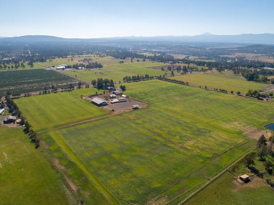 Welcome to a wonderful farm opportunity where simple living is at it's finest with scenic views of the Cascade Mountains. This sizeable hay farm is located in the desirable Tumalo area which provides 35 acres of the 39, Swalley water rights with included irrigation equipment. There is plenty of room to store hay under the giant hay barn & outbuildings. Animals will have security on this cross fenced flat land haven, in the barn or loafing sheds. The options are open for riding under the covered arena & corral. Surrounded by lush native landscape is where a cozy home lies. After a day on the farm relax inside and enjoy the Mountain views next to a warm fire. Store all the Toys with the preservation of covered parking, plus added simplicity of RV hook ups and RV dump. The RV dump is located at the newly installed septic. Invest in this land as you choose the lots are dividable. Enjoy the country lifestyle a few minutes away from Bend & close access to the Redmond Airport.