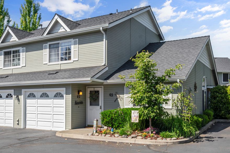Originally the model home, this beautifully maintained 1,435 sq.ft. townhouse offers spacious, open living w/vaulted tongue-and-grove ceilings and newer laminate flooring & carpet throughout. The main-level primary suite features a vaulted ceiling, walk-in closet, and an ensuite with tub/shower & oak linen cabinetry. The well-appointed kitchen opens seamlessly to the dining and living area, highlighted by a river rock fireplace, abundant windows, and direct access to a large, private, covered patio, ideal for relaxing or entertaining. Upstairs, you will find two generous bedrooms w/vaulted ceilings, large closets, and expansive view windows, plus a full bath w/step-in shower and oak cabinetry. Located in a manicured, park-like community with HOA covered water, sewer, landscaping, clubhouse, exterior maintenance, and pool. Conveniently close to shopping, dining, medical facilities, and all the beauty and recreation the Rogue Valley has to offer. Low maintenance living at its finest!