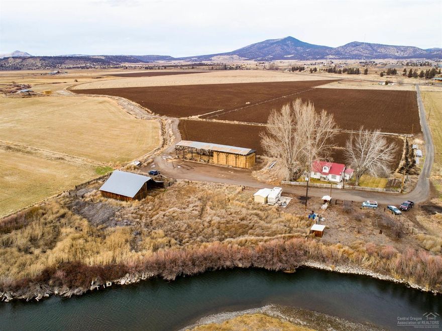 Excellent opportunity to own a large, irrigated farm just minutes from Prineville with excellent access and visibility from Highway 26, plus 5,000+/- feet of Crooked River frontage! This farm has been in the same family for many years! Excellent soils, irrigation district water rights, 2 homes, hay shed, old barn. Farming & residential tenants in place! Fish and hunt ducks, geese & quail right on your own property!