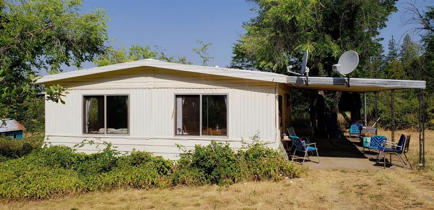 Incredible Mountain Views!!!!! 1972 double wide sits on a knoll with 2 bedroom 1 bath on 4.16 acres. One car garage/shop/carport. Property has a gentle slope.