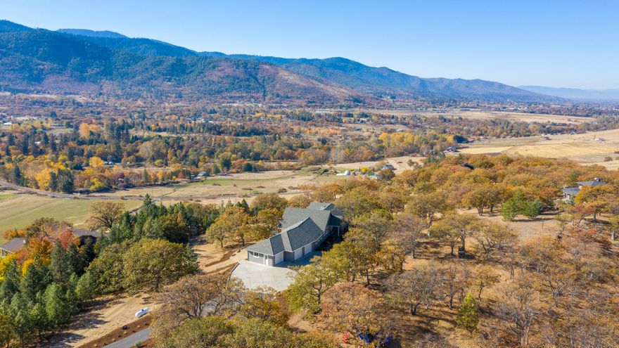 Extraordinary style and elegance in this close-in rural property. There is incredible versatility in the floorplan and endless views in almost every direction. Main floor includes a gourmet kitchen with top of the line appliances, quartzite countertops and heated wood floors. Vaulted dining room with slider access to the deck and two sided fireplace. Impressive living room with views of Mount Ashland. Main level features a stunning master suite with spa-like bathroom plus two additional bedrooms & guest bath. The lower level boasts an additional family room with fireplace, office/gym space, room for a classroom or overflow living plus a great guest suite setup. Attached three car garage, lower level workshop, boat barn, and the list goes on. Professionally landscaped, expansive outdoor spaces for entertaining and just a stone's throw to Emigrant Lake. Every surface in this home has been updated and will please the most discriminating buyer.
