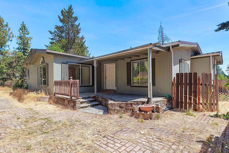 This 5 acre property boasts a private and secluded location with a nearly 2000 sq. ft. home featuring a split floor plan, vaulted ceilings in the living room and abundant natural light. The home offers a generously sized kitchen, spacious bedrooms and lots of storage space. At the rear of the home is a wonderful sunroom with large picture windows to take in the views, nature and wildlife. Additional features include a detached garage with workshop and loft, a seasonal creek and gated driveway. Lots of potential here! Just needs some TLC and your personal touches to make it shine again. Property being sold as-is. Priced to sell quickly!