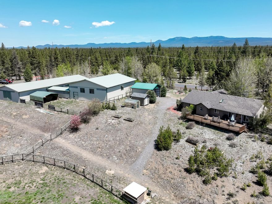 NEW PRICE: Escape to over 12 acres of serene Central Oregon beauty w/ great views of Mt. Bachelor & private access to the sparkling Little Deschutes River create a truly unmatched lifestyle. Ideally located just minutes from Downtown La Pine, Quail Run Golf Course, & Sunriver Resort, this property delivers the perfect blend of privacy, recreation, & convenience.   The charming 3-bedroom, 2-bath home features vaulted ceilings, wood floors, a cozy wood stove, A/C, & an open-concept layout that flows seamlessly into a spacious, inviting kitchen. Step outside & enjoy a park-like natural pasture setting, unforgettable sunsets, & a sense of peace that feels worlds away.  Equestrian lovers will appreciate the exceptional barn setup featuring 11 stalls, including two 12x18 foaling stalls, a 36x36 indoor turnout, & an enclosed breezeway leading directly to a 50x60 indoor riding arena. Additional perks include a greenhouse, sheds, & ample RV/boat parking.  This is mountain living at its finest.