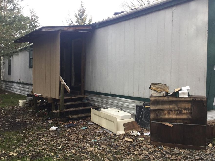 Great 1.5 acre lot zoned residential commercial. The 2 bed/2 bath manufactured home has been gutted. There is quite a bit of debris and clutter that seller is working to remove. Open to a reasonable as-is offer. Seller will carry loan. Call listing agent for more information.