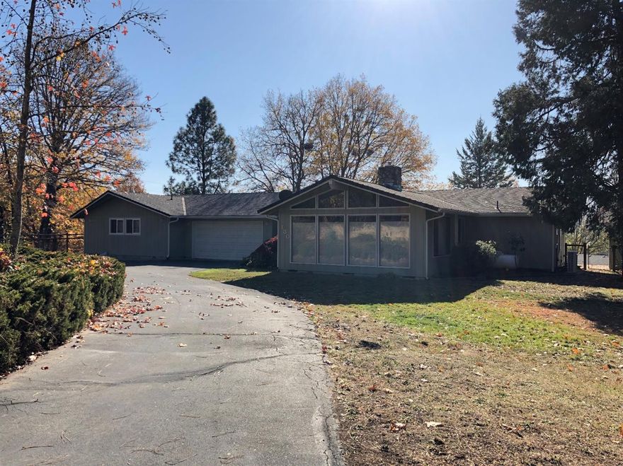 Rare opportunity for this very tastefully updated 4 bedroom home. The home has a split floor plan which can give an option for a separate guest quarters area that gives this home multiple options for its use of the floorplan. Outside is an expansive deck that overlooks the back yard and provides nice territorial views. Interior features include a propane fireplace, a ductless HVAC system, granite kitchen counter tops and formal dining area. There is an additional detached shop which can serve multiple purposes.