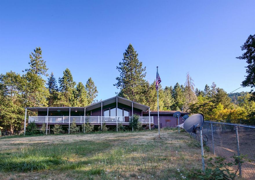 Ride around your own personal horse paradise on this 5-acre, multifamily setup! The main home boasts 2 bedrooms, a spacious living room with vaulted ceilings and huge windows that let in an abundance of natural light. The kitchen is open with an enormous amount of cabinetry; perfect for your inner chef! The master bedroom is huge, with a large closet and spacious bathroom. There is a private slider off the master onto the covered deck which is equipped with a hot tub! There are two separate barns set up with rubber mats, tack room, hot/cold water, & outbuildings. The 'Lifetime' barn is totally enclosed with sliding doors on the front & back, concrete breeze way & foundation. 3-12x12 stalls lined with steel & locking sliders on front/back entry. 12x24 totally covered pipe enclosure off back of stalls, & security fence. Second barn is Mare Motel style barn with a slab concrete foundation. The stalls are 12x24 & fully covered. Round pen, arena that is topped w/sand. The guest house locate