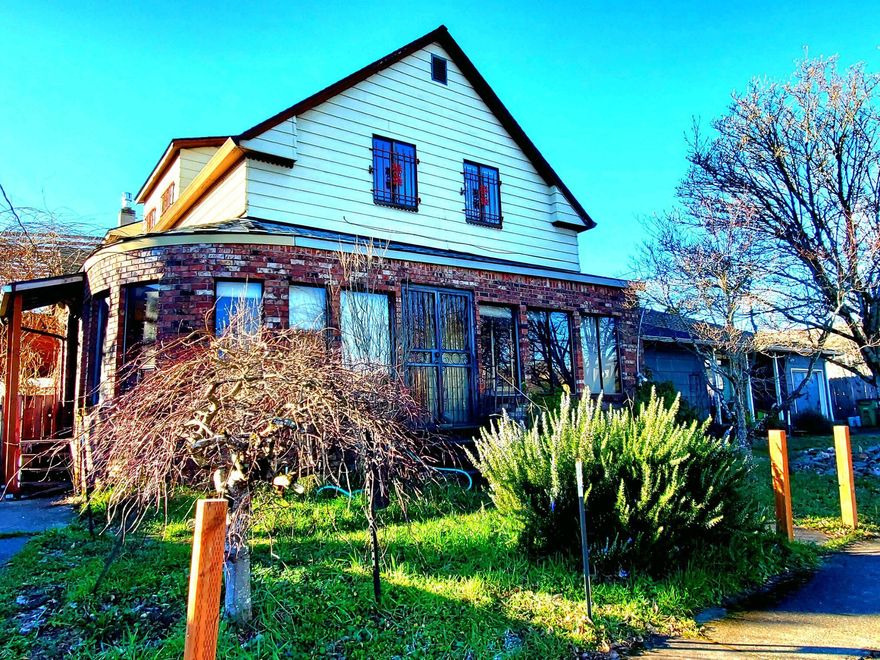 The potential is endless on this vintage home with old school charm.  They don't build them like this anymore. Great bones, redwood walls, archways, hardwood floors with design inlay. The brick entry way is so charming and inviting it just needs a little love! This is a fixer but has the potential to also be updated into 3 units.  Each floor has it's own full bath, kitchen, and entry. This property is a block away from the updated Lents neighborhood with hip new shops, bars and restaurants.