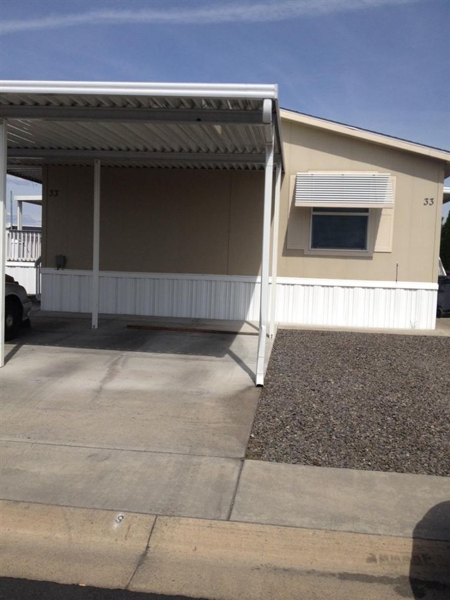 Super clean 2006 manufactured home in Sunset Estates. 3 bedrooms, 2 baths with vaulted ceilings & open floor plan. Nice, newer Trex deck and easy care landscape. 10 x 12 wooden storage shed perfect for tools or extras.