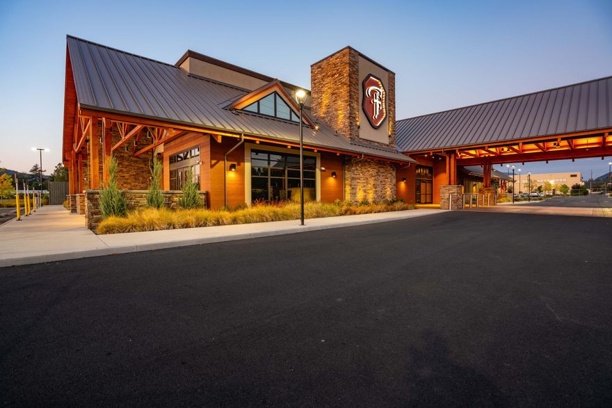 A generational opportunity - welcome to The Flying Lark. An homage to the famous Grants Pass racehorse from the 1980s, The Flying Lark was a visionary project to become a regional landmark. Now, the property stands as a blank slate for an ambitious developer to create the West Coast's next entertainment destination. As a rare open market offering, the facility spans nearly 37,000 SF. From the architecturally stunning exterior, guests are led to the 10k+ SF main floor, anchored by the ornate central bar, and flows through to a full-service restaurant, sports bar, stage, and much more. An industrial-quality catering kitchen, loading dock, storage rooms, office suites and conf. rooms are tucked out of the public eye. Best viewed in person, it's evident each detail was meticulously thought out, with material choice at the forefront. The truly one-of-a-kind property is ready for a visionary developer to leave their mark on the future of Southern Oregon! Additional land may be available.