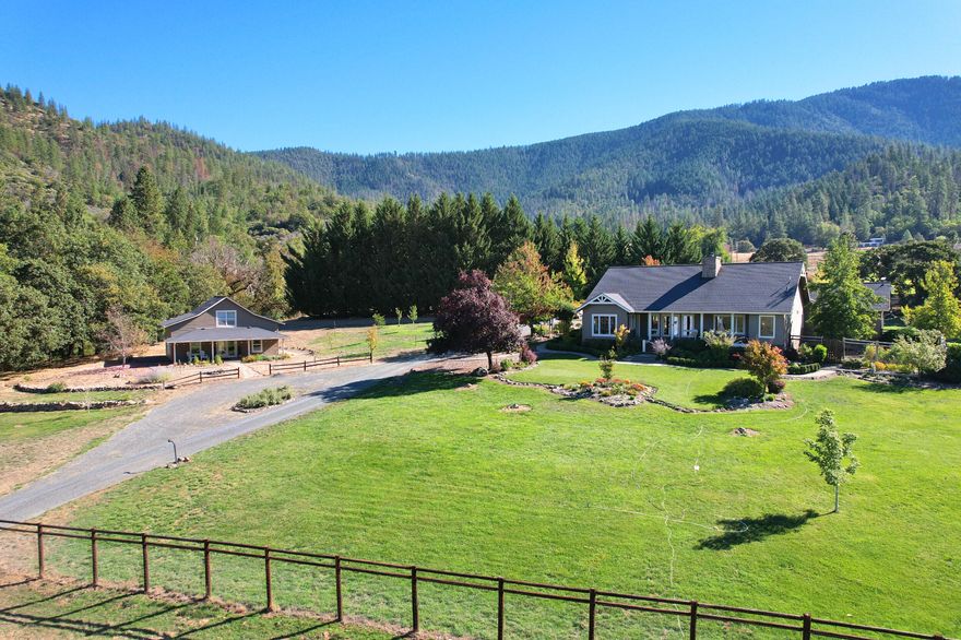 Small Ranch Living in the Applegate Valley. 2 homes in beautiful setting. Main 2383 sq.ft. light-filled, open concept home w/ chef's kitchen, breakfast nook & formal dining area. Living room w/ stone fireplace & views of gardens, pastures & mtns. Bonus room, wrapped in windows & perfect for morning coffee & evening relaxation. Master suite w/ walk-in closet & unique shower full of natural light. Additional beds are roomy w/ 3rd bed ideal for office or guests. Guest cottage w/ kitchen, vaulted upstairs bed, ample storage & private patio. Perfect for extended family & visitors. Equestrian & Agricultural friendly w/ high quality horse barn w/ concrete floors & matted stalls. Older pole barn w/ room for feed, equip. & animals. Smaller shed for more storage & smaller livestock. Fenced & X-fenced acreage, beautiful English gardens, deer fenced area, double gated & ample parking. 2 producing wells plus water rights off 2 creeks. Self sufficient w/ generator set-up & Starlink internet.