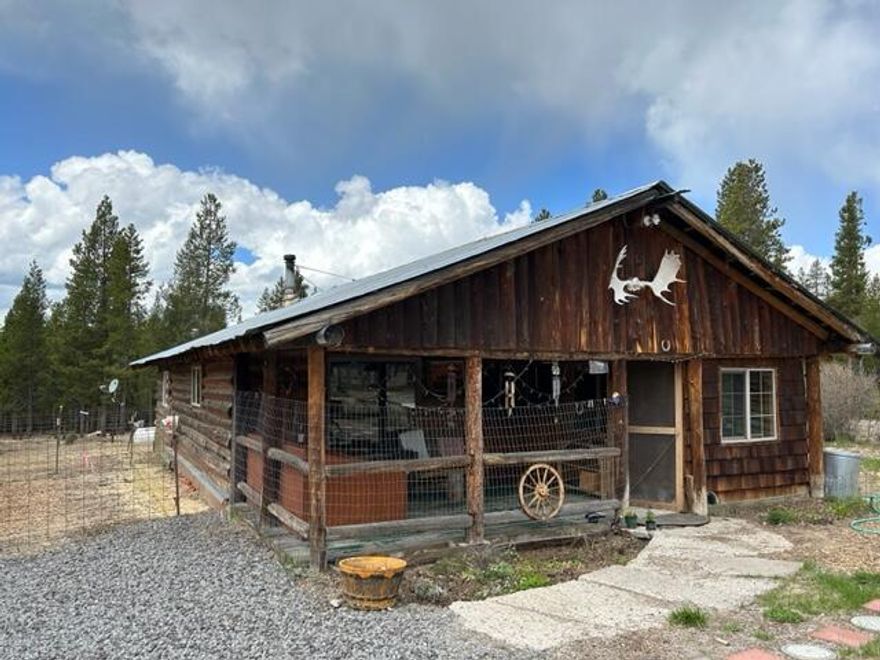 MOTIVATED SELLER: This rustic log cabin needs some TLC but is clean & well maintained. 2 bedroom, wood stove, & Propane heater warms the whole house. Fantastic 5.5 acre property has been cleared. Great horse property! Easy access to BLM Land and trails galore. Shop for storage can house RV's 220 Elec. to the Large, Shop 2 wells