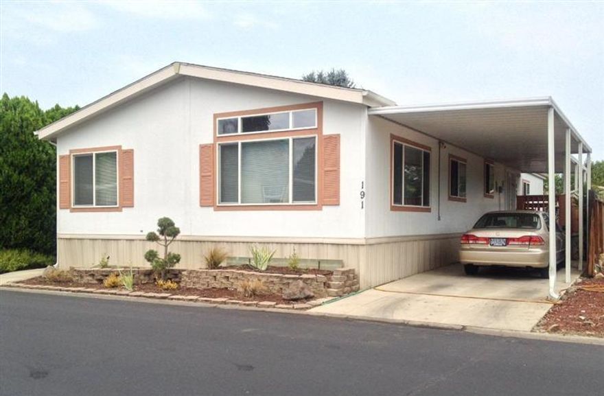 Welcome home to this Spacious 4 bedroom home in the Medford Estates Family Park. This home is 1960 Sq. Feet with a split floor plan and was built in 2002. It has a large open Kitchen with plenty of counter top space, lots of storage/pantry and has an island. There is both a Living Room and Family Room as well as a breakfast area and a formal Dining Room. This home has a Large Covered Deck for enjoying time outdoors. The home also has a large Laundry Room and includes the Refrigerator, Freezer, Washer & Dryer, Blinds, a Large Projection TV, Storage Shed, Fruit Trees, & Carport. The Medford Estates includes many amenities, including: Security Service in the evenings, Hot Tub, Large Pool, Gym, Sauna, Weight Room, Library and Beautiful Recreation Room with Pool Table, and exquisite Kitchen and more!!!