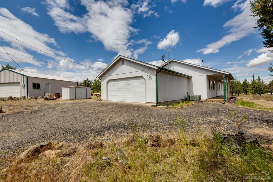 Spacious & bright, this 3 bedroom, 2 bath home is ready to go! Covered deck & patio for year round outdoor enjoyment & a great 864 sq foot shop for hobbies & storage. Double car garage, storage building & additional fenced garden area. Home offers a great room style layout w/ pellet stove for efficient winter heat. Laminate floors, farmhouse style accents in the kitchen & plenty of storage! Lg bedrooms & French doors to the Master Suite. Located just off Upper Davis & close enough to town & the lake!