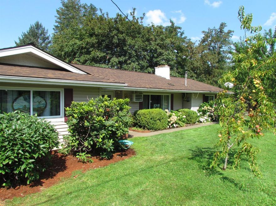 Just minutes from Chinook County Park on the majestic Rogue River, this charming 3 bedroom, 2 bath home on a large, gated .42 acre lot with Grants Pass Irrigation rights includes a 2-car garage PLUS an 18' x 16' finished, electrified shop, gorgeous landscaping & mini-orchard with mature peach, pear, plum, apple & cherry trees. With energy efficient construction, the home requires very little heat & A/C & features comfy living & dining areas with a beautiful slate fireplace plus a convenient breakfast bar kitchen for casual dining. The split-bedroom floor plan has the custom wood ceiling, private master suite at one end & two additional bedrooms & full bath at the other. 2 sliding doors open onto the back patio where the fresh air & hummingbirds abound. Updates include vinyl windows, slate & laminate floors & a recent roof system. Low county taxes & your own sparkling well water, yet so convenient to medical services, shopping, schools & more. Call for a look inside today!