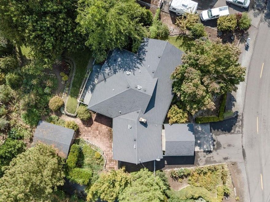 Boasting over 2500 sq. ft on almost 1/2 acre is a rare find. RV parking, small shop, garden and more. As you enter the home you will find a great living room with a cozy fireplace. There is a dining area and a very large remodeled kitchen complete with an island and plenty of cabinets and counter space. There is a bonus room currently being used as the library but can become a game room/ sunroom or other. All bedrooms have hardwood floors. The master bedroom has 4 closets and a very large bathroom with a two sink vanity, seperate shower and tub. The other two bedroom are very large also. The family room sits on the other side of the home and has it's own entrance. Updated windows, solar tubes are also found. There is a covered deck that overlooks the back yard, garden and flora. A beautiful courtyard seperates the house and shop. Must tour.