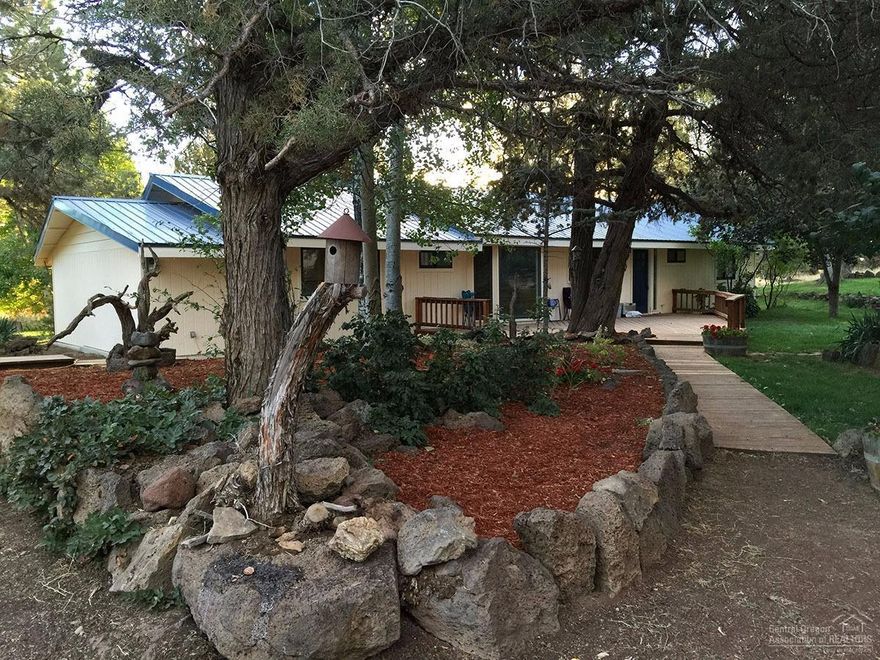 Much sought-after home on small acreage with irrigation, pastures, barn and studio. This pristine single-level farm house has just been painted inside and out, new floor coverings, refreshed landscaping, immaculate barn with shop. Two fenced pastures, one irrigated and one natural. Beautiful property with junipers, outcroppings, pond and canal. Private water company. 2 water heaters. Located back from the highway about 1/4 mile.